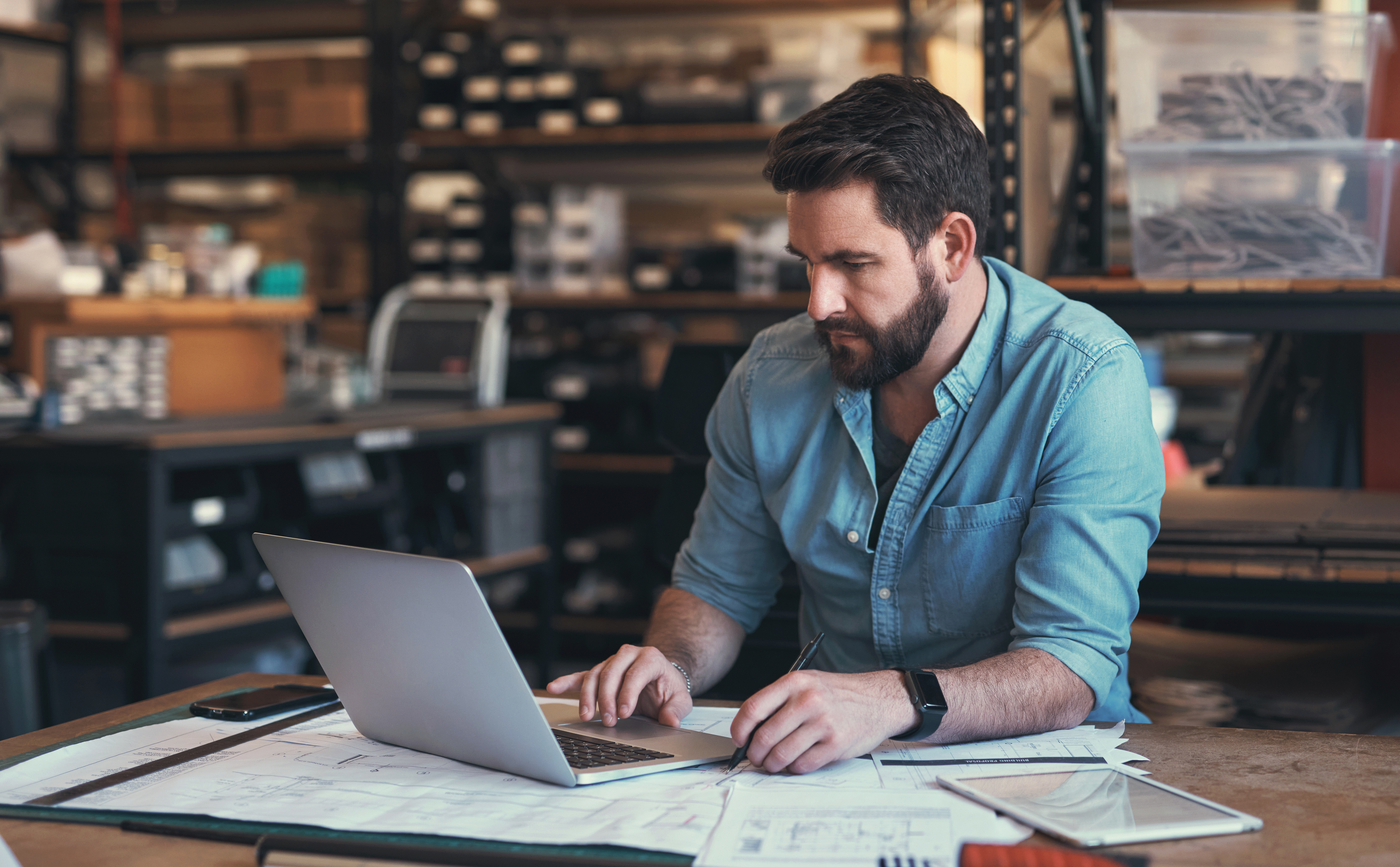 A business owner reviews his cashflow plan on a laptop.