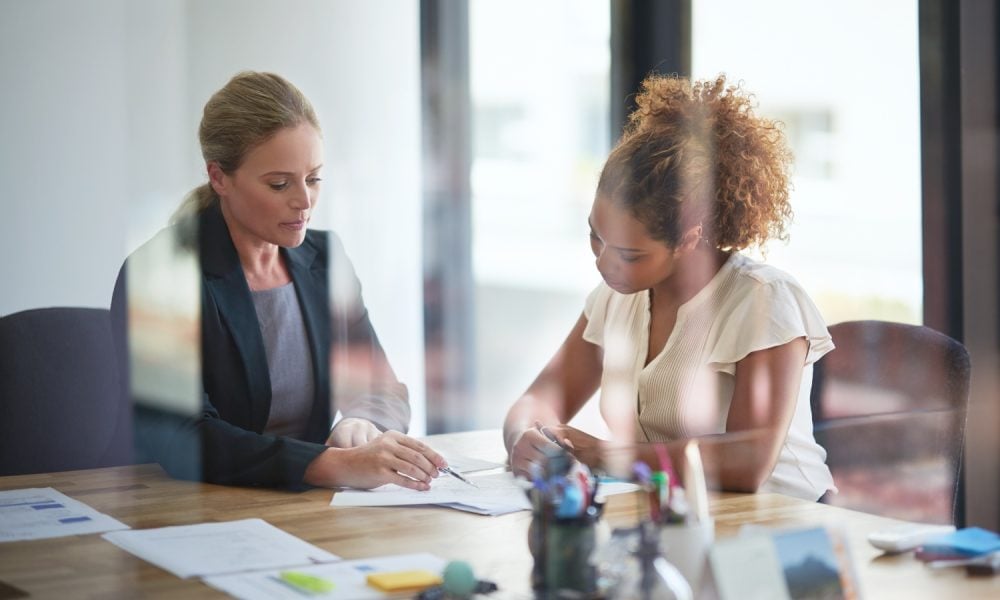 Woman, client and financial advisor in meeting for contract, discussion and consulting for investment. Glass, explain or accountant in office speaking of advice or compliance for terms and conditions