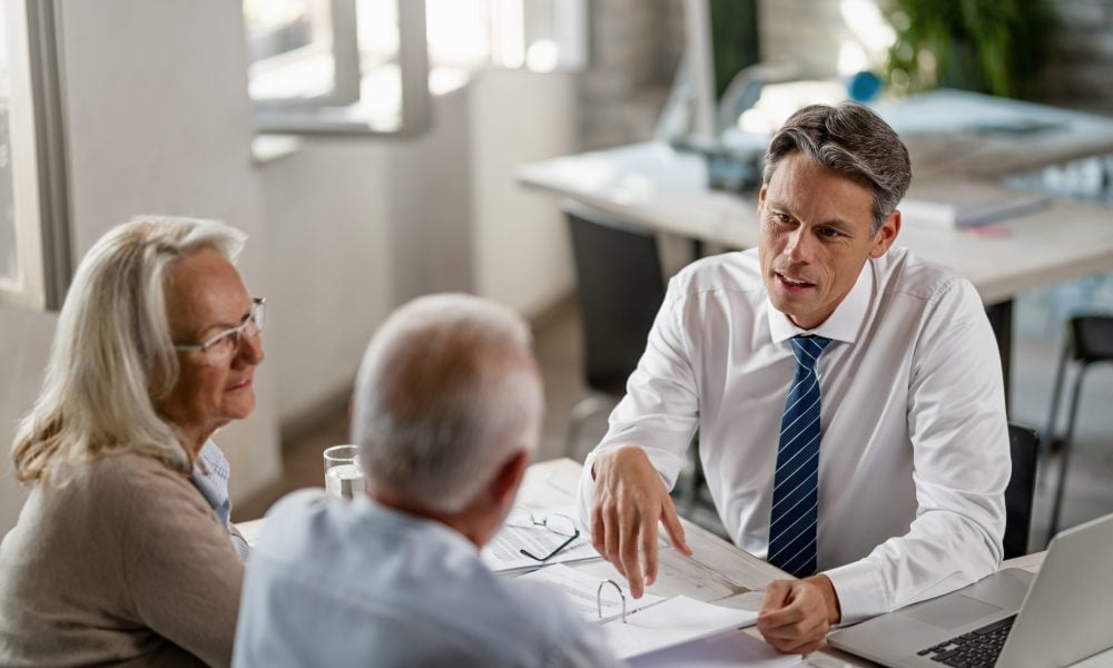 A couple reviews their family trust with their accountant.
